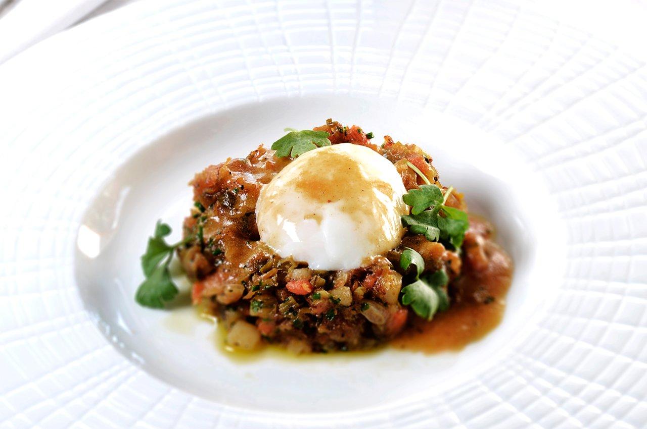 Image of turkey hash with a poached egg and hollandaise on top